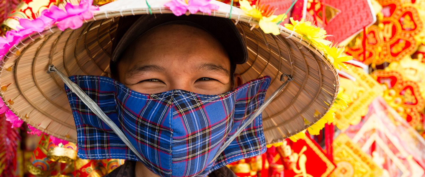 woman in straw hat with cloth face mask