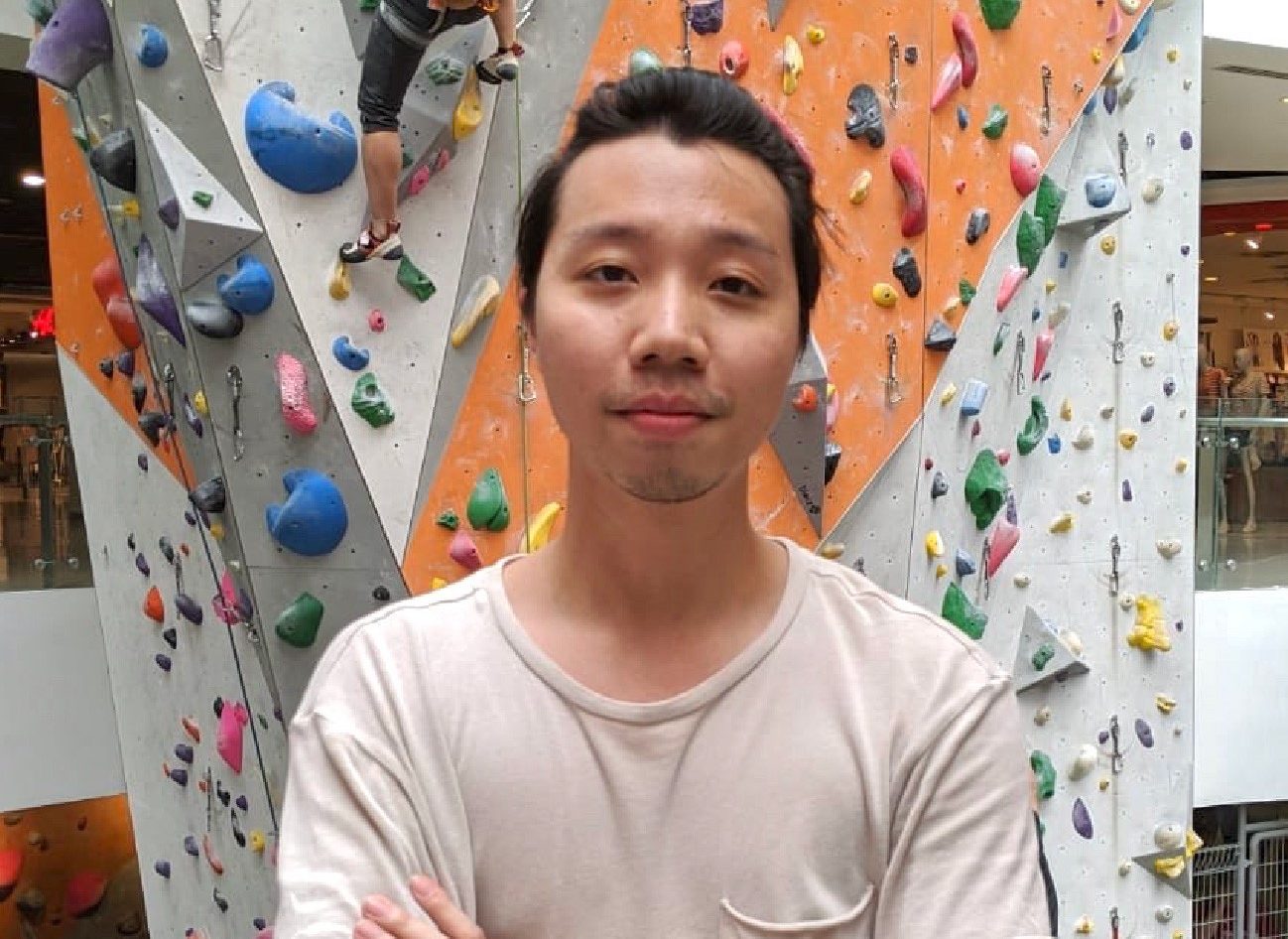 man standing in front of climbing wall