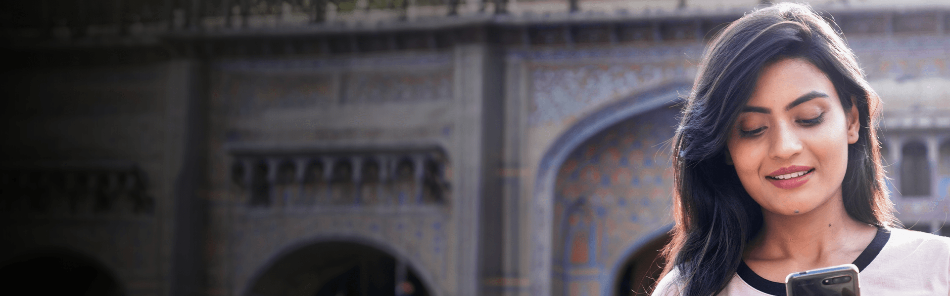 Young indian woman looking at mobile phone