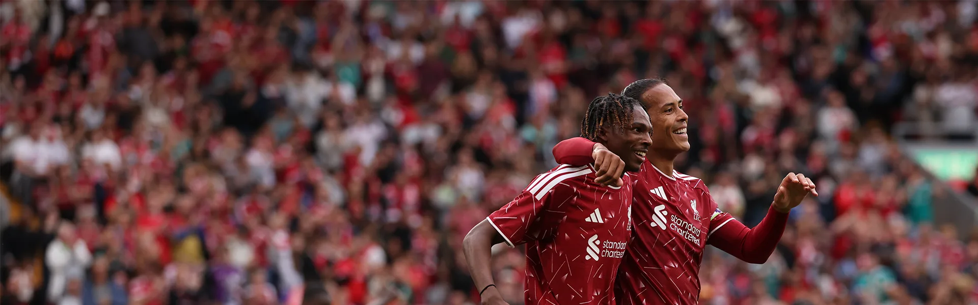 Liverpool players celebrate on the pitch.