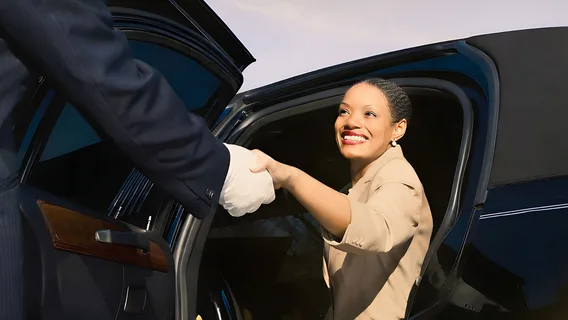 A Private Bank client steps out of a limousine. 