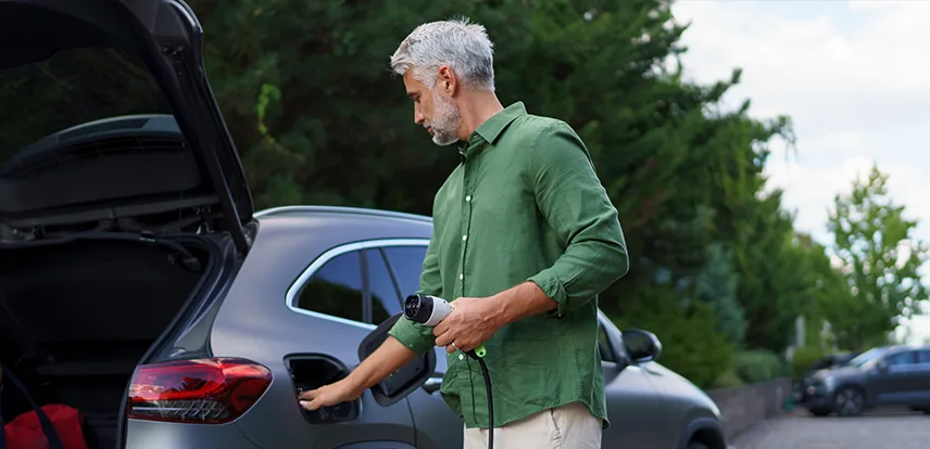 Man charging an EV.