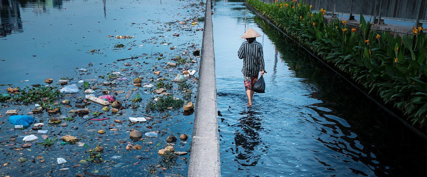 Man walks alongside plastic waste