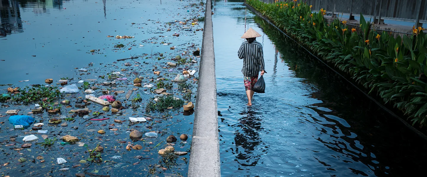 Man walks alongside plastic waste