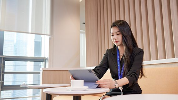 A Standard Chartered employee completes AI training on an iPad.