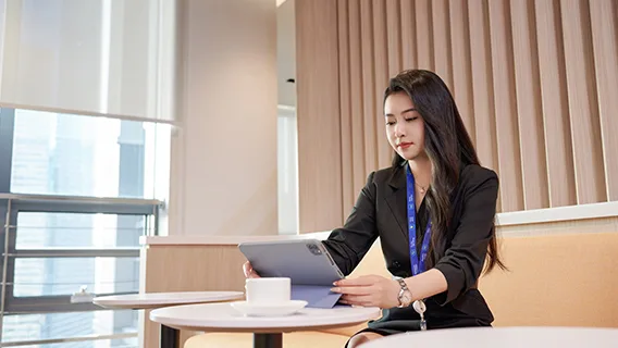 A Standard Chartered employee completes AI training on an iPad.