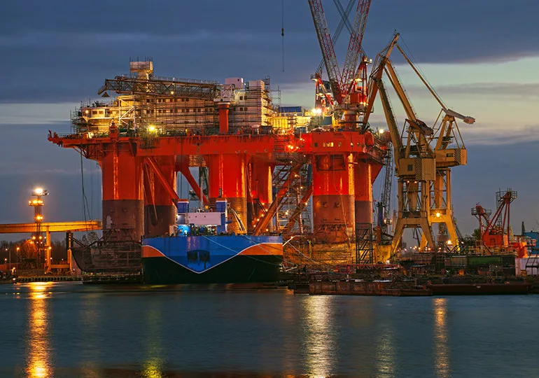 oil rig lit up at night