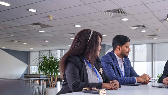 A group of Standard Chartered employees discuss our business model.