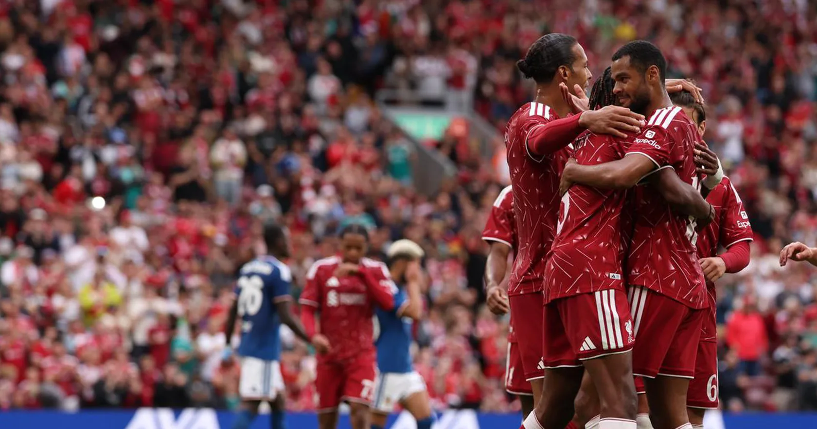 Liverpool FC players celebrate together on the pitch.