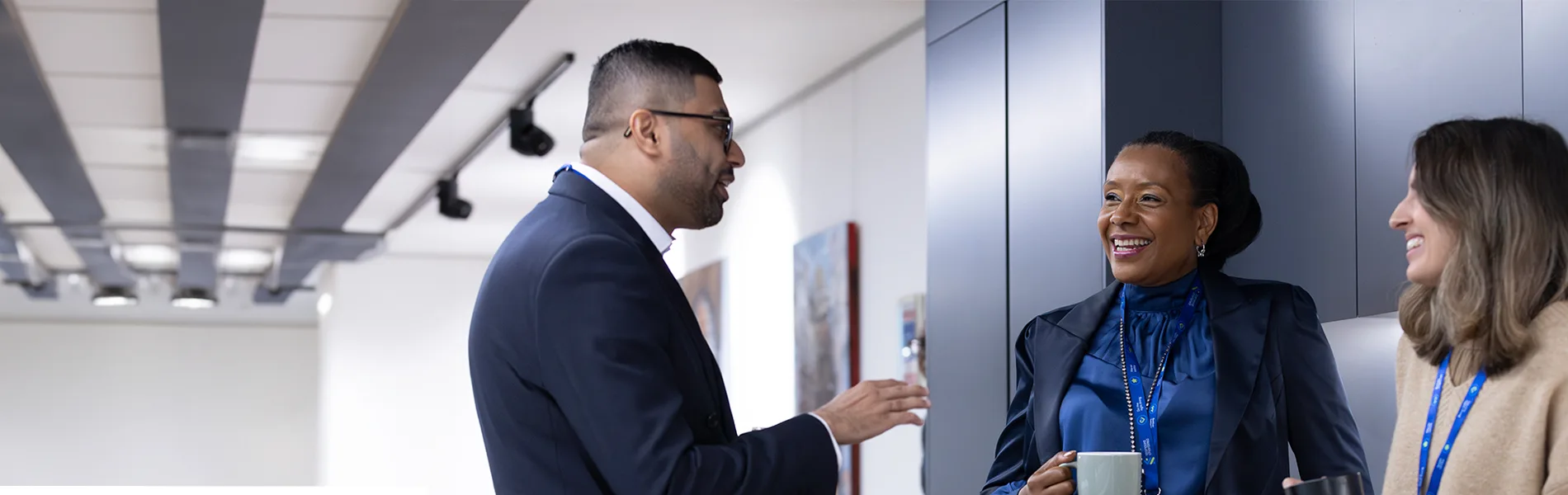 Two colleagues laugh together at Standard Chartered's London HQ.