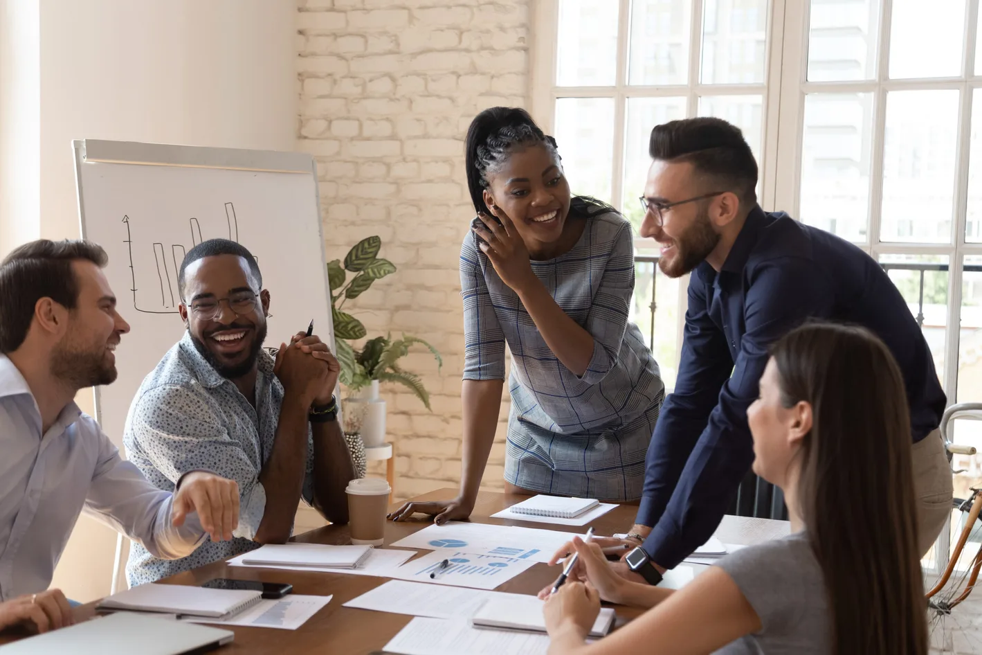 A group of employees discussing in office