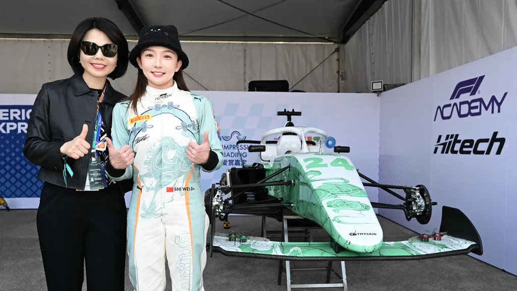 Thumbs up in front of her race car.