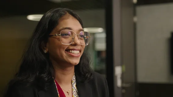 A lady with glasses smiling