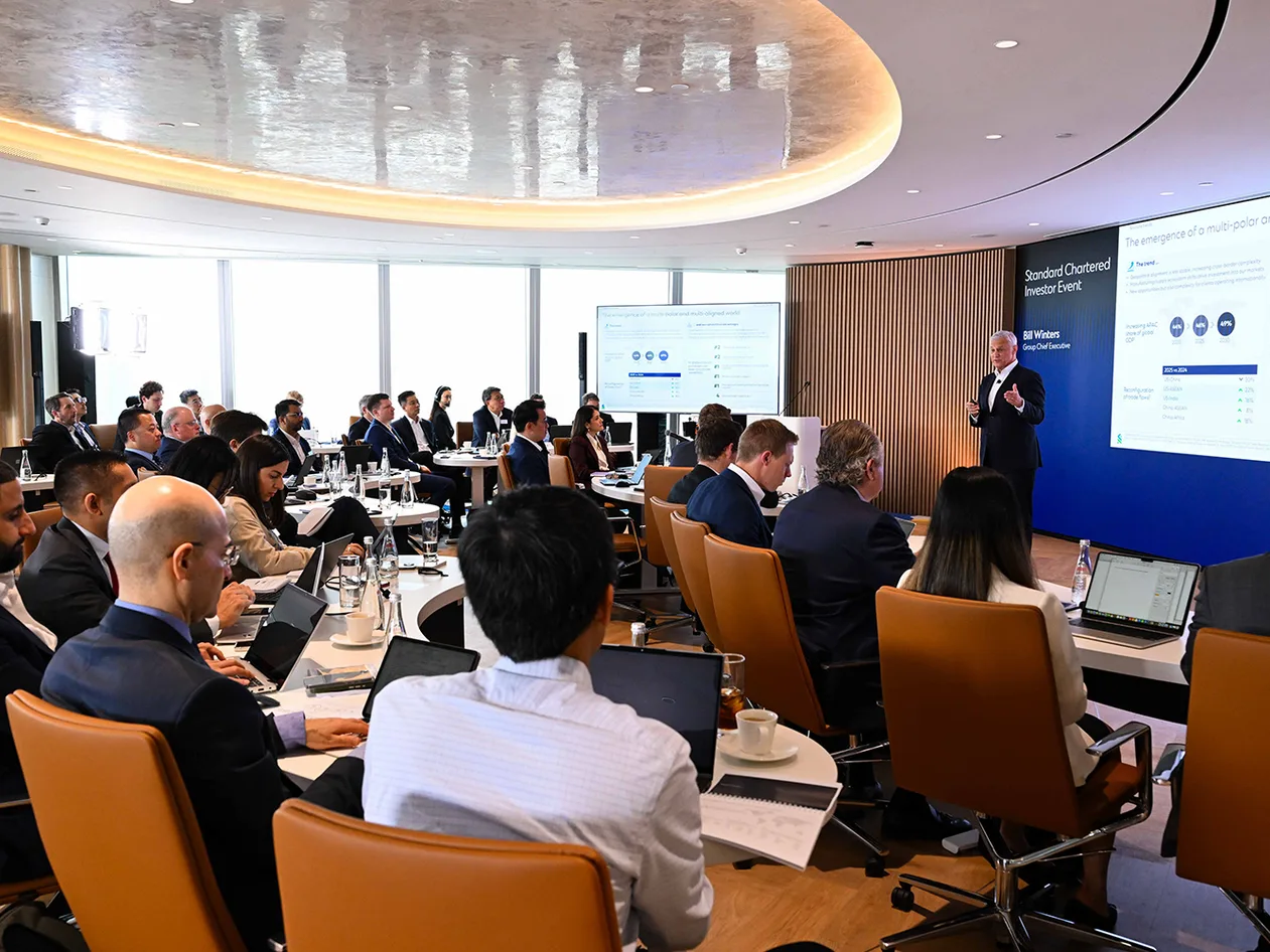 People watch a presentation at the Standard Chartered 2026 Investor Event.