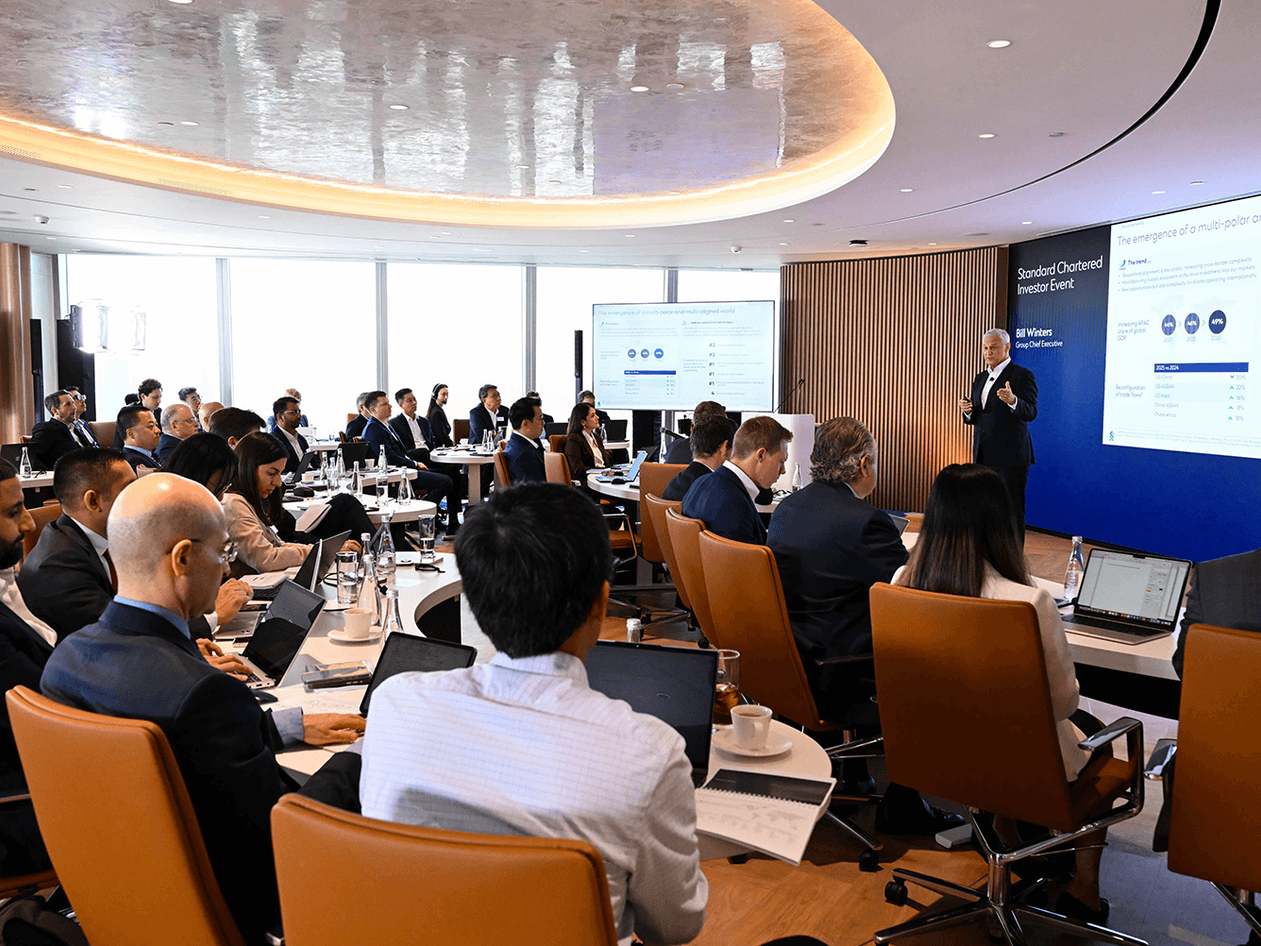 People watch a presentation at the Standard Chartered 2026 Investor Event.