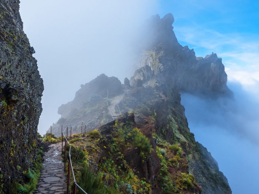SC Global Research image of walk way in high mountains surrounded by clouds