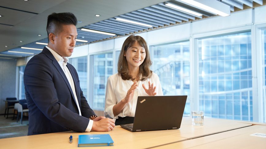 Colleagues with laptop talking
