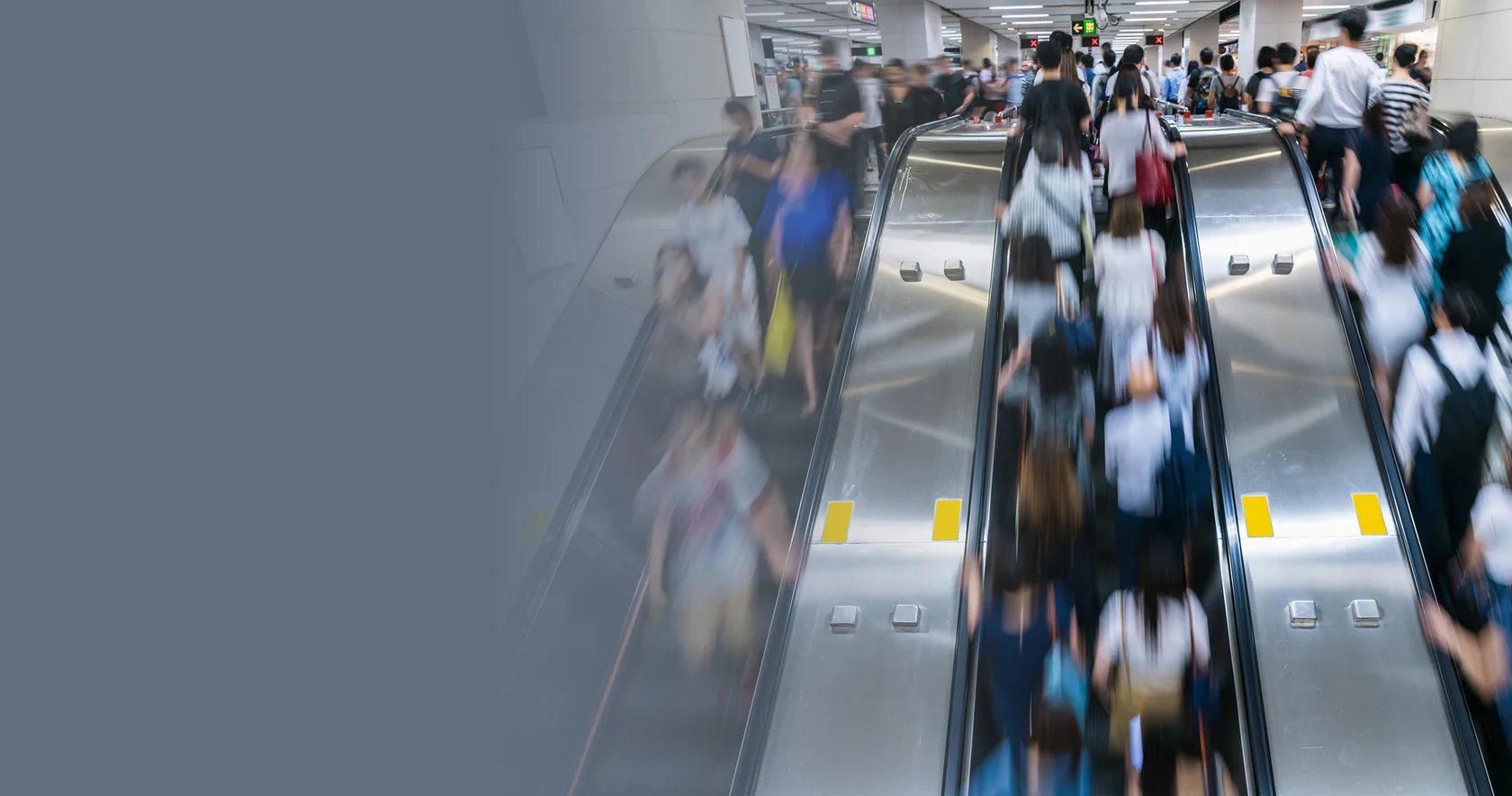 people standing on an escalator