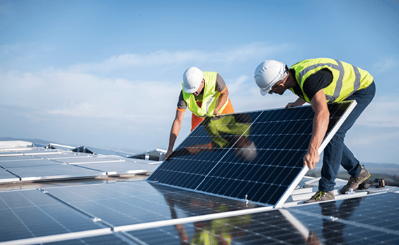 Men at work laying out solar panels