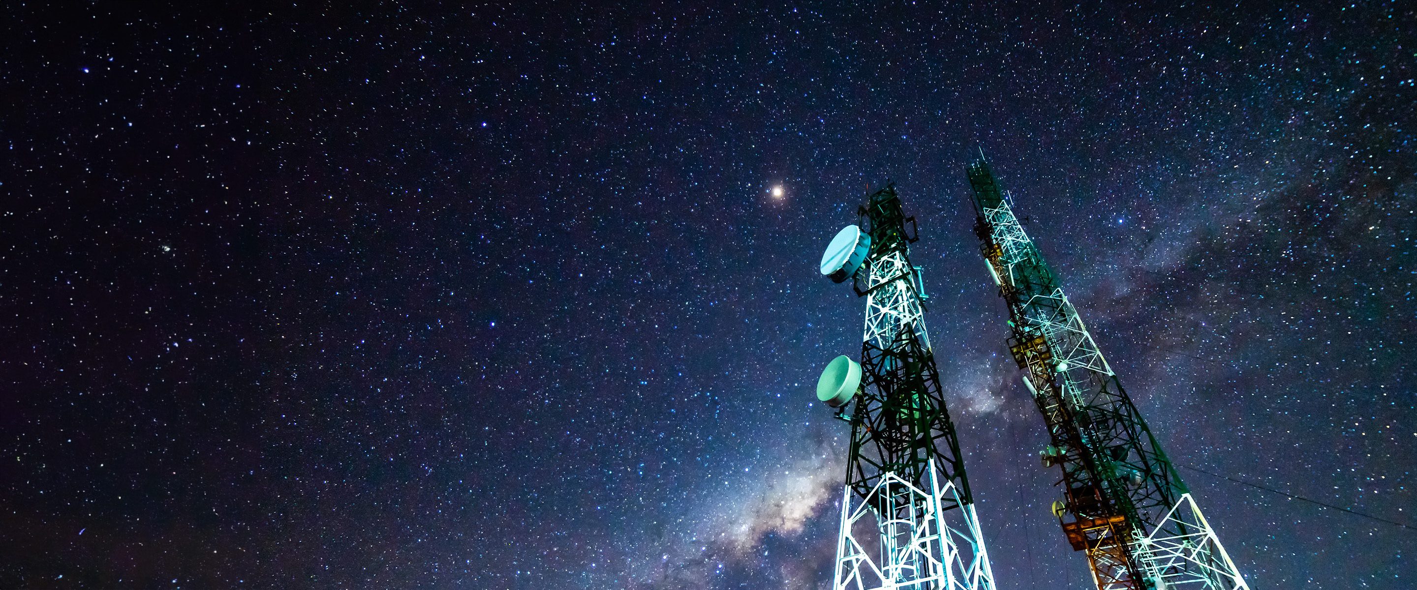 A road over two islands with a boat under the channel.
