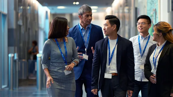 Colleagues walk together in a Standard Chartered office in Singapore.