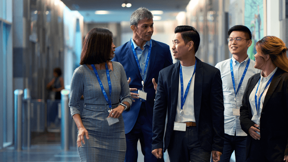 Colleagues walk together in a Standard Chartered office in Singapore.