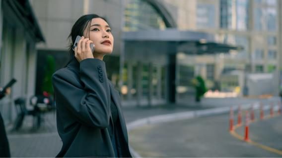 Young woman on mobile phone in city