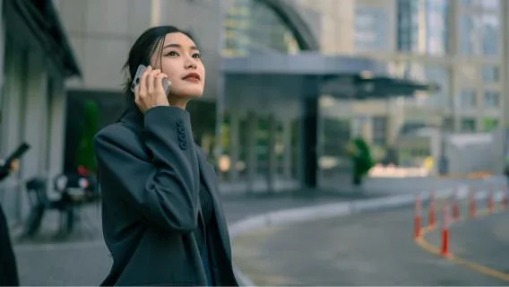 Young woman on mobile phone in city