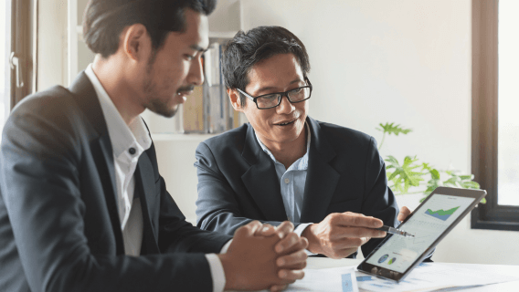 two men working on a tablet 
