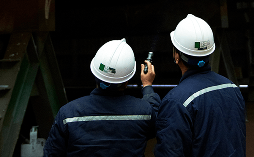 Korean workers at a port check a shipment to Saudi Arabia.