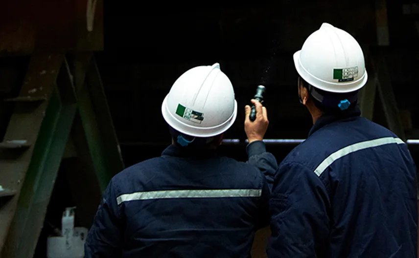 Korean workers at a port check a shipment to Saudi Arabia.
