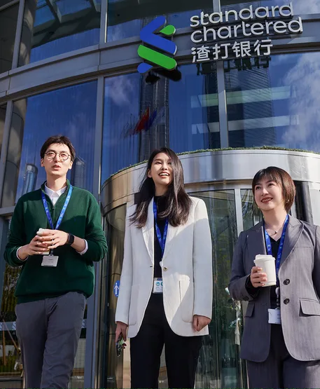 Smiling colleagues share a coffee outside the office in Shanghai