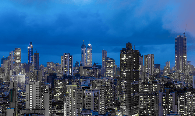 A city skyline under a blue sky reflecting the rise of the global Indian.