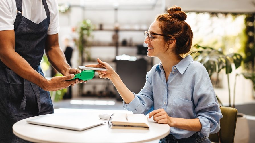 Female customer making contactless payment