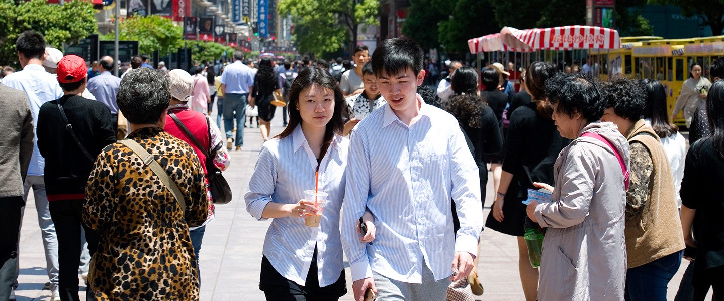 young couple walking through crowd