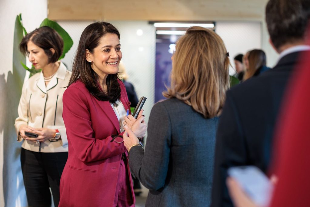 Chief Strategy & Talent Officer Tanuj Kapilashrami  smiles at a participant while hosting a roundtable on AI as a catalyst for reinvention.