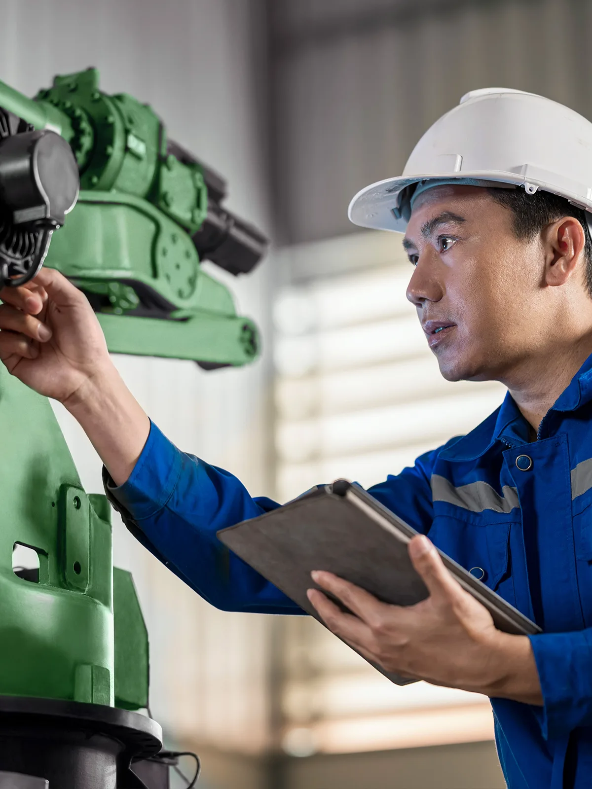 An engineer works on a machine.