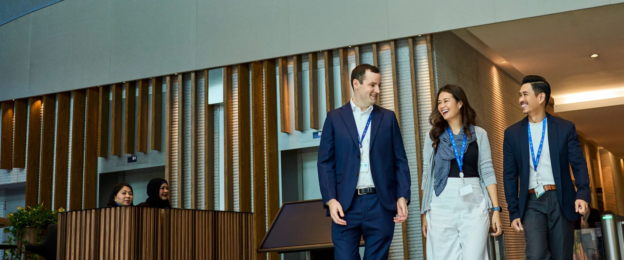 Two women walk outside a Standard Chartered office