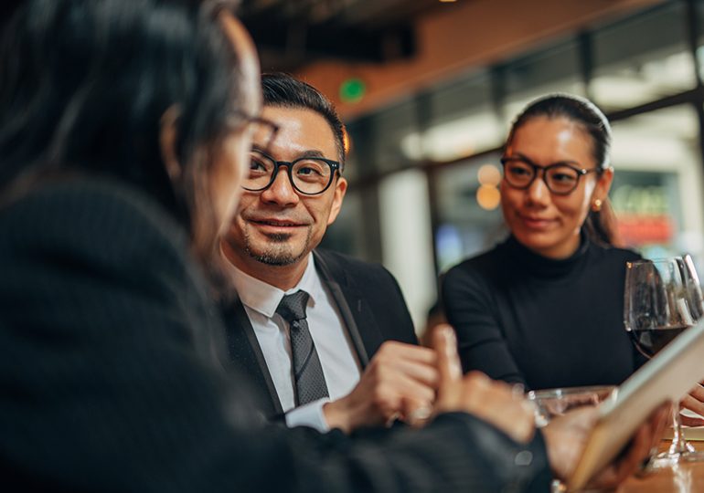 A group of people in formal wear discussing