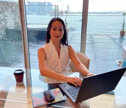 A picture of Winne Law working on a laptop