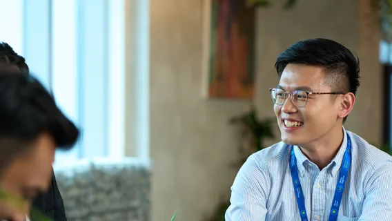 A young man in a blue shirt in an office.