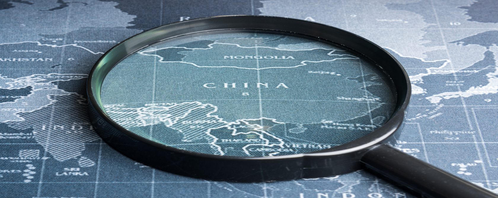A map with a magnifying glass showing China