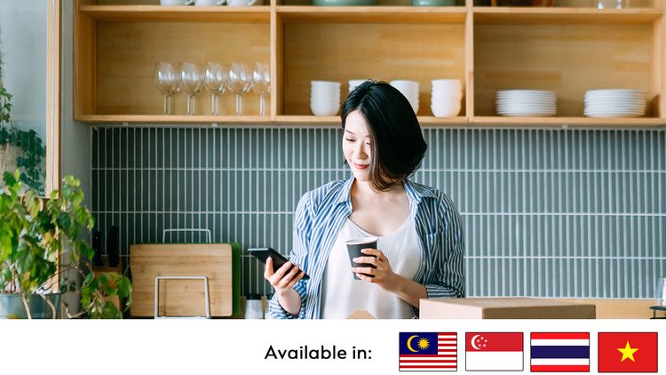 woman using phone and holding cup