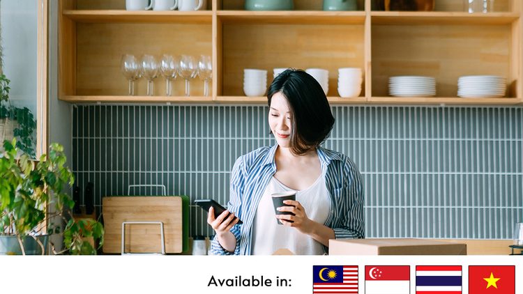 woman using phone and holding cup