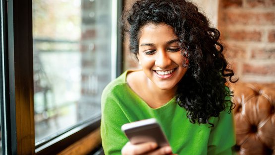 woman smiling at phone