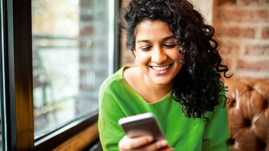 woman smiling at phone