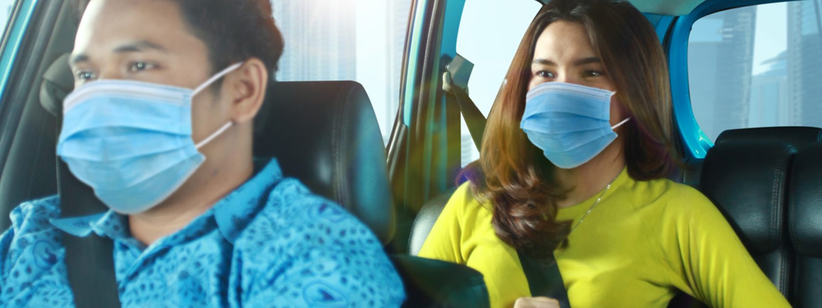 2 people in car wearing face masks