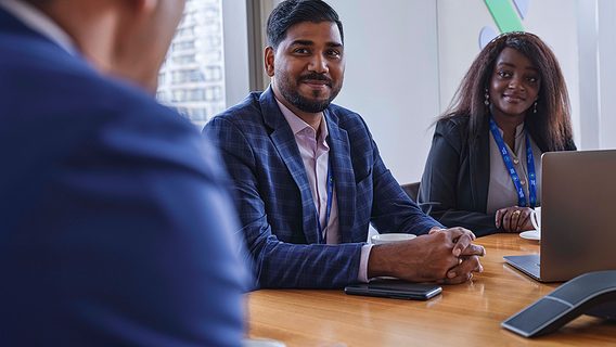 Three people discussing in a meeting