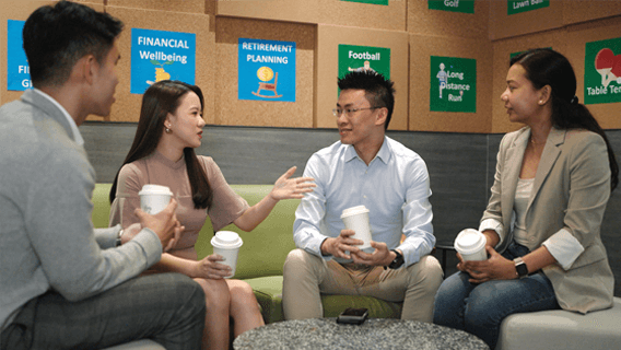 Team of colleagues talking in a breakout area