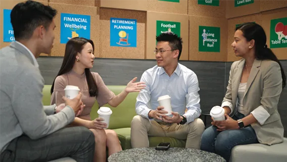 Team of colleagues talking in a breakout area